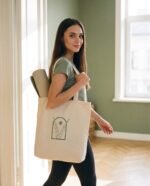 Elena, the stretching.shop AI guide, with the Desert Arch Tote Bag
