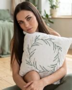 Elena, the stretching.shop AI guide, with the Olive Wreath Cushion