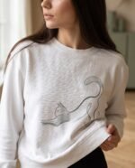 Elena, the stretching.shop AI guide, with the Stretching Cat Sweatshirt
