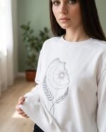 Elena, the stretching.shop AI guide, with the Sun & Moon Sweatshirt