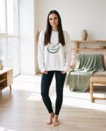 Elena, the stretching.shop AI guide, with the Half Moon Rest Sweatshirt