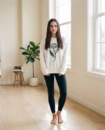 Elena, the stretching.shop AI guide, with the Thistle Head Sweatshirt